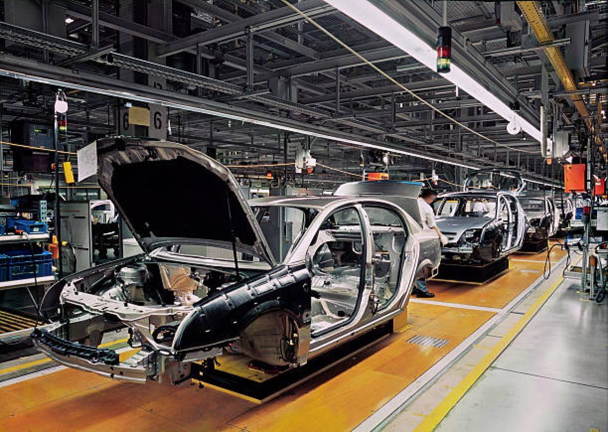 car production line with unfinished cars in a row How On-Metal RFID Tags Boost Auto Manufacturing Efficiency