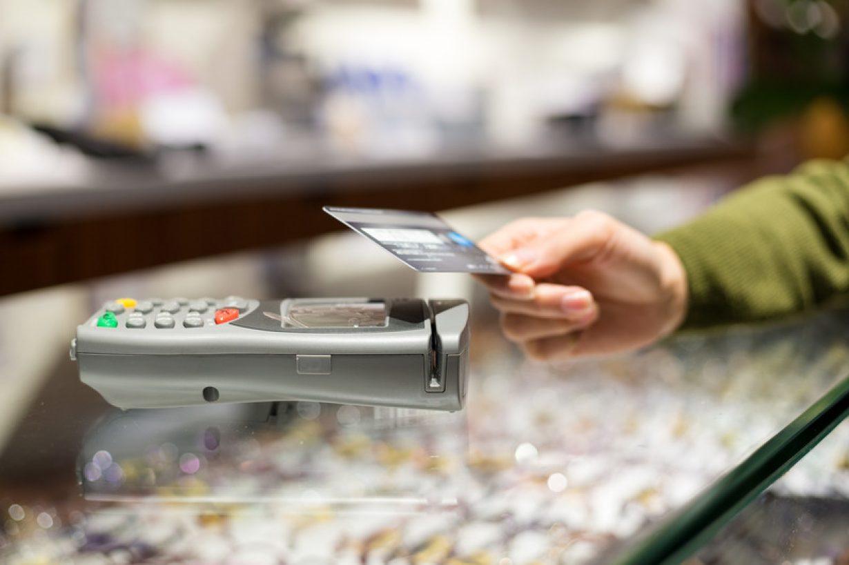 Woman pay by credit card with NFC How RFID Cards Bring Secure Payment Systems